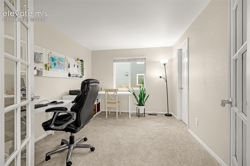 9127 Oakmont Road Peyton, CO 80831 - Photo 14 of 49 a view of a workspace with furniture and a window