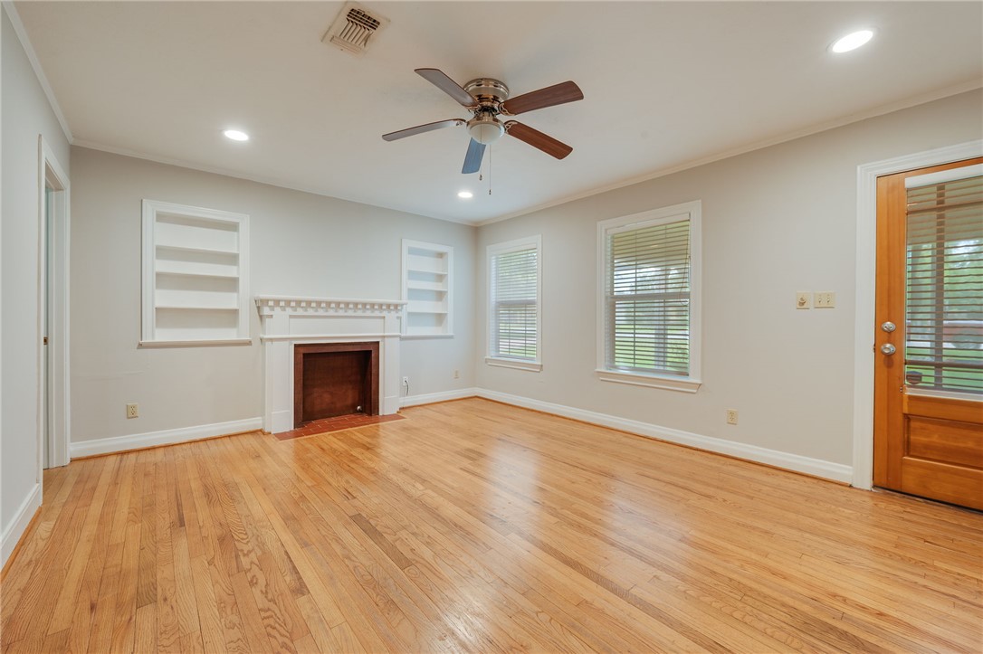 715 Inwood Drive Bryan, TX 77802 - Photo 4 of 34 a view of an empty room with wooden floor and a window