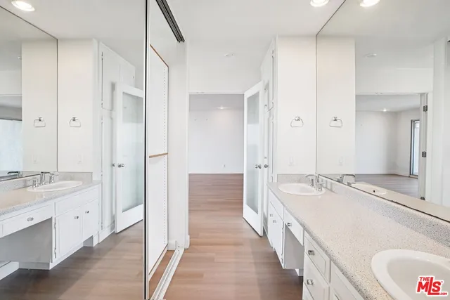 a kitchen with a sink appliances cabinets and a window