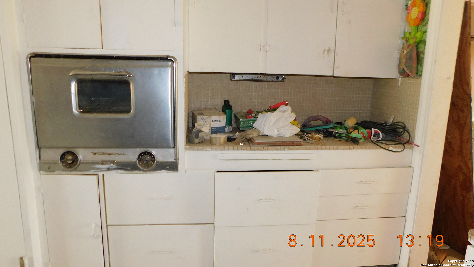 11620 Highway 16 Poteet, TX 78065 - Photo 27 of 38 a bathroom with a sink and cabinets