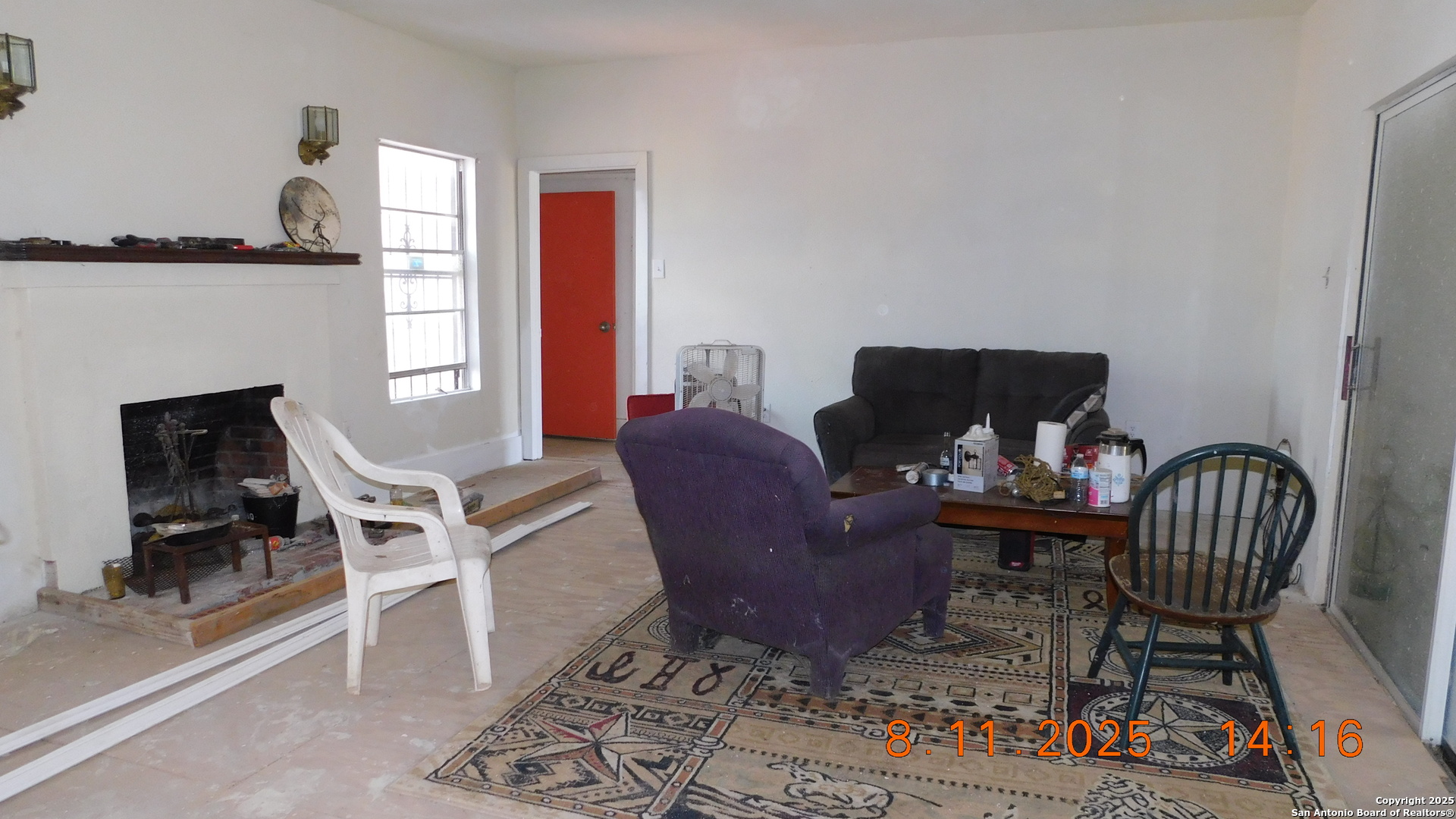 11620 Highway 16 Poteet, TX 78065 - Photo 29 of 38 a living room with furniture a rug and a fireplace
