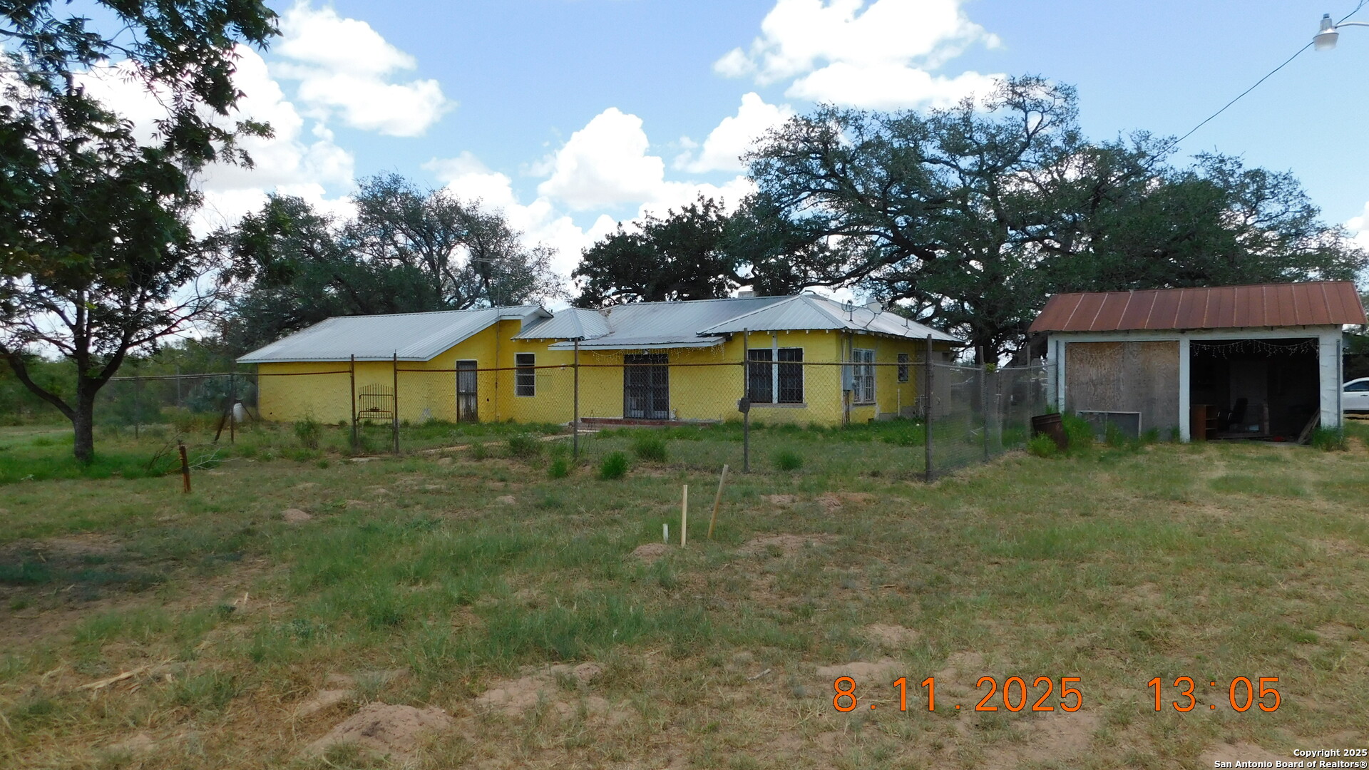 11620 Highway 16 Poteet, TX 78065 - Photo 5 of 38 a front view of a house with a yard