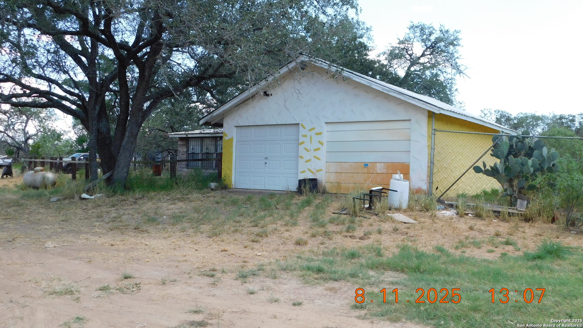 11620 Highway 16 Poteet, TX 78065 - Photo 9 of 38 a small barn with a small yard and a large tree