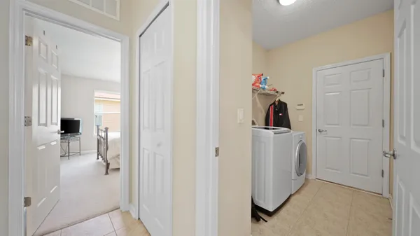a view of a hallway with closet and a livingroom view