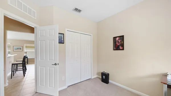 a view of a livingroom with a flesh screen tv and wooden floor