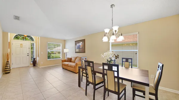 a view of a dining room with furniture and window