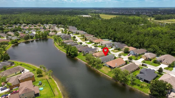 an aerial view of a house with a lake view