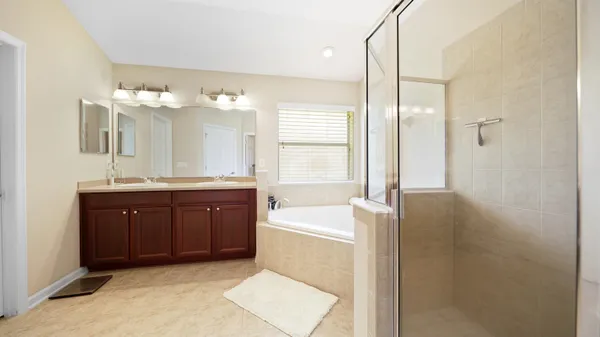 a bathroom with a tub sink and mirror