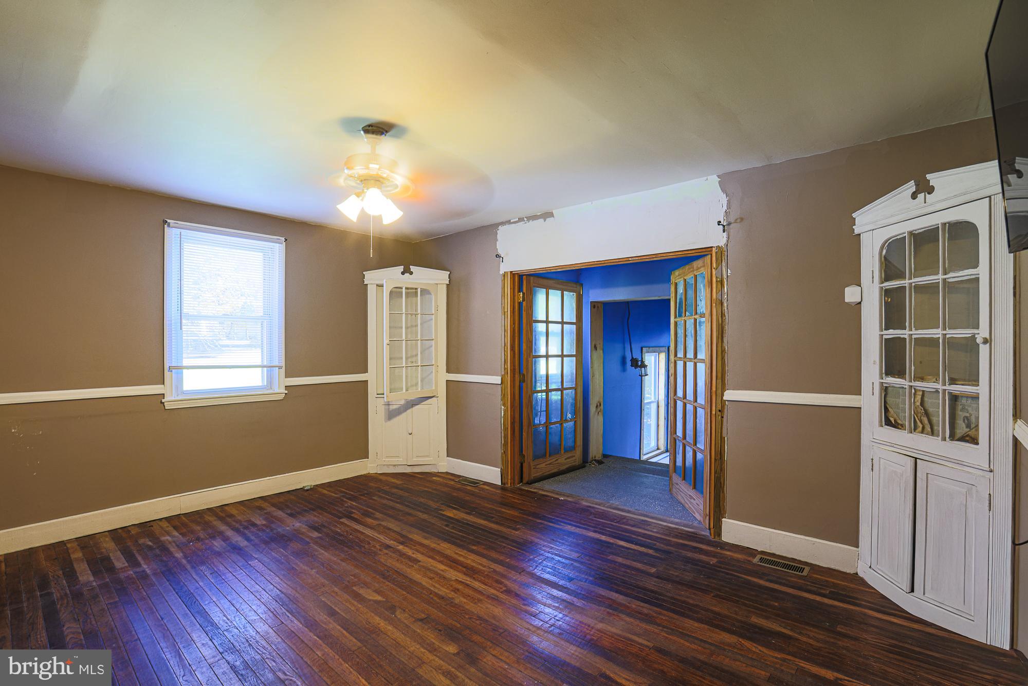 7215 Rockridge Road Baltimore, MD 21207 - Photo 11 of 62 a view of an empty room with window and wooden floor