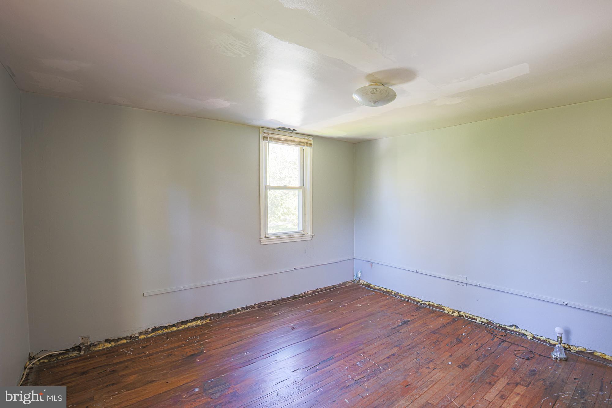 7215 Rockridge Road Baltimore, MD 21207 - Photo 41 of 62 an empty room with wooden floor and windows