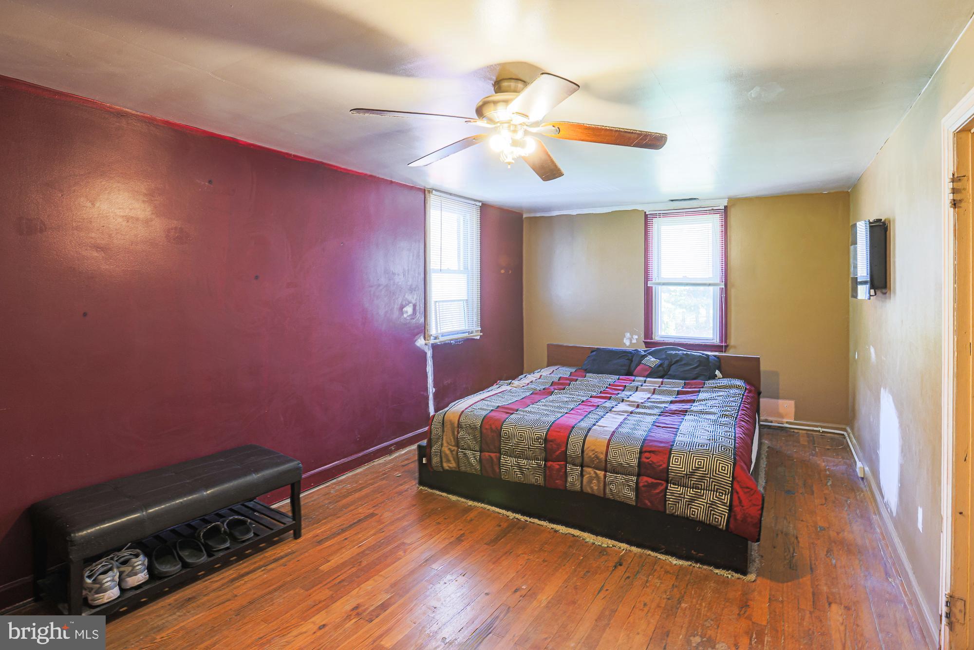 7215 Rockridge Road Baltimore, MD 21207 - Photo 42 of 62 a bedroom with a bed and a chandelier