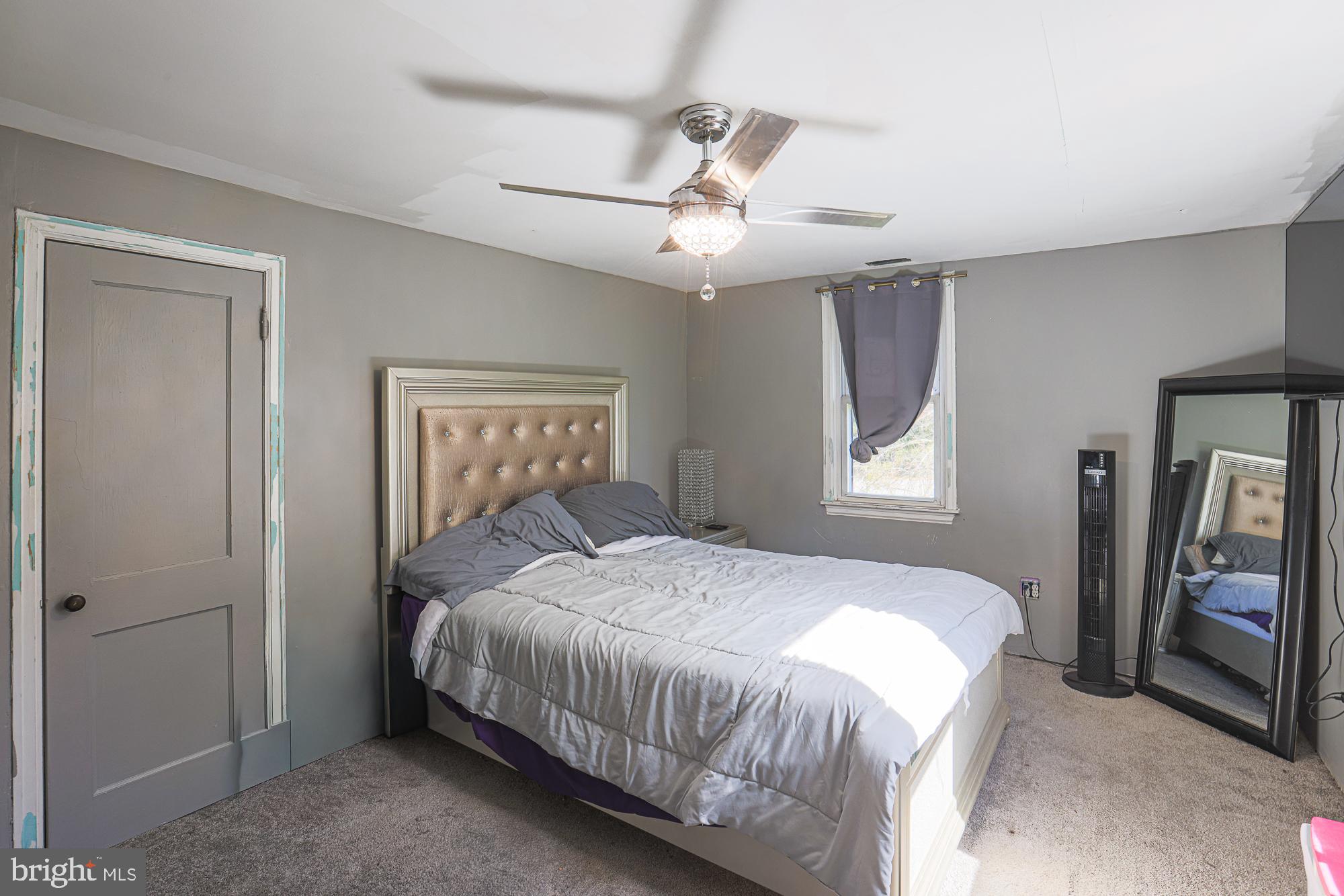 7215 Rockridge Road Baltimore, MD 21207 - Photo 47 of 62 a bedroom with a bed next to a window