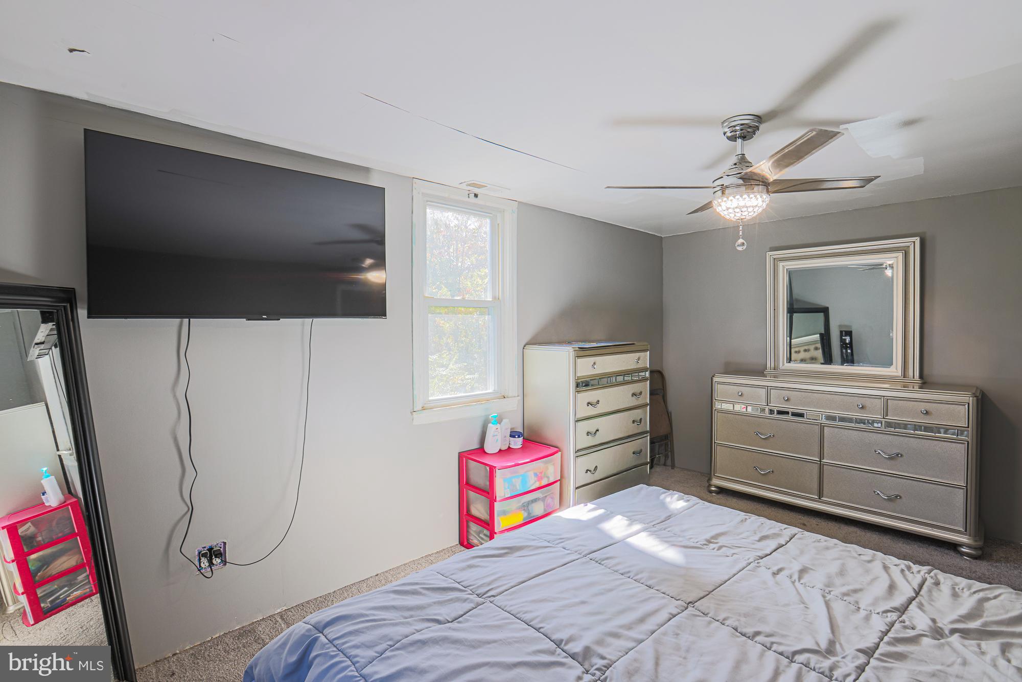 7215 Rockridge Road Baltimore, MD 21207 - Photo 49 of 62 a bedroom with a bed and a flat screen tv