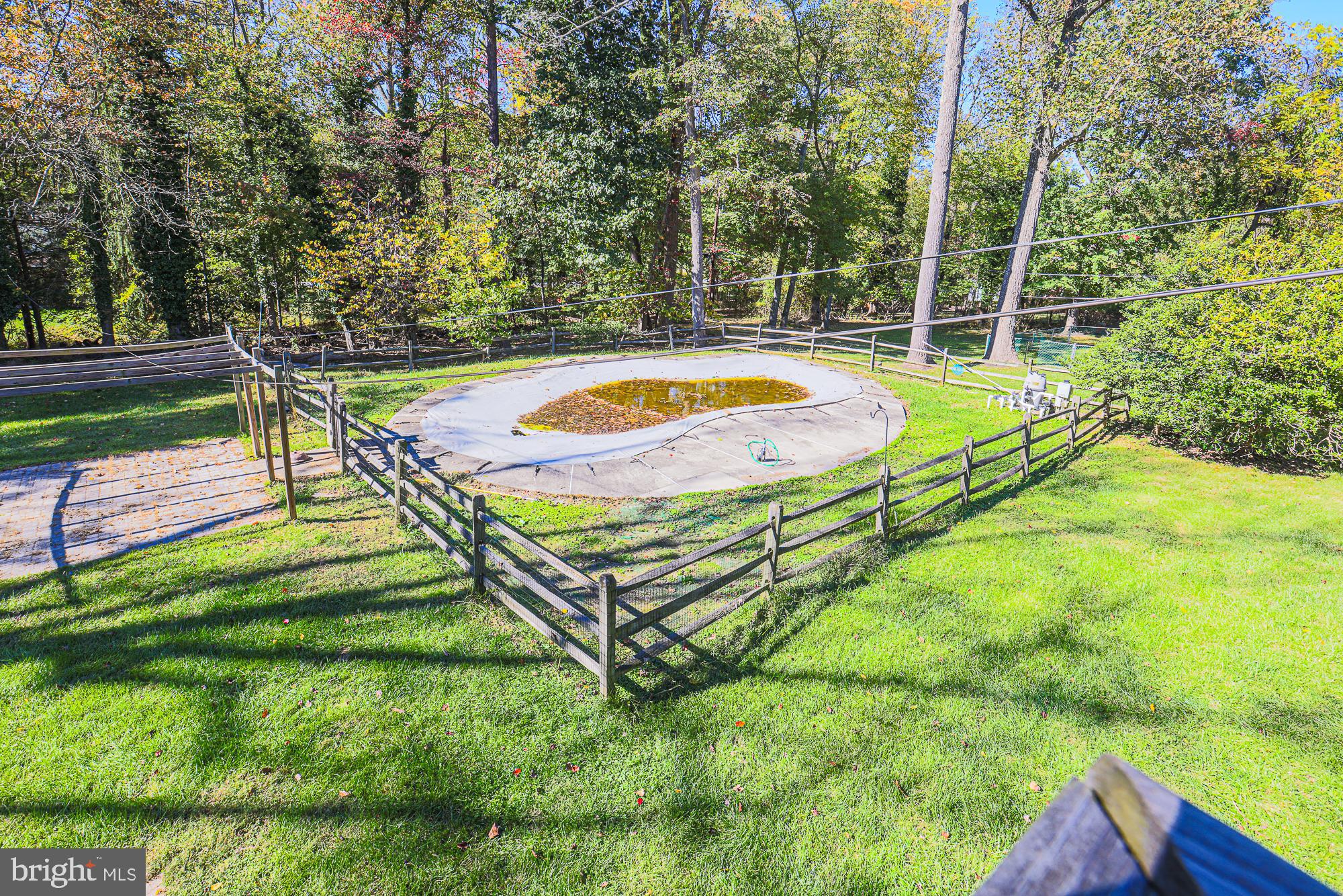7215 Rockridge Road Baltimore, MD 21207 - Photo 54 of 62 a view of a swimming pool with a yard and large trees