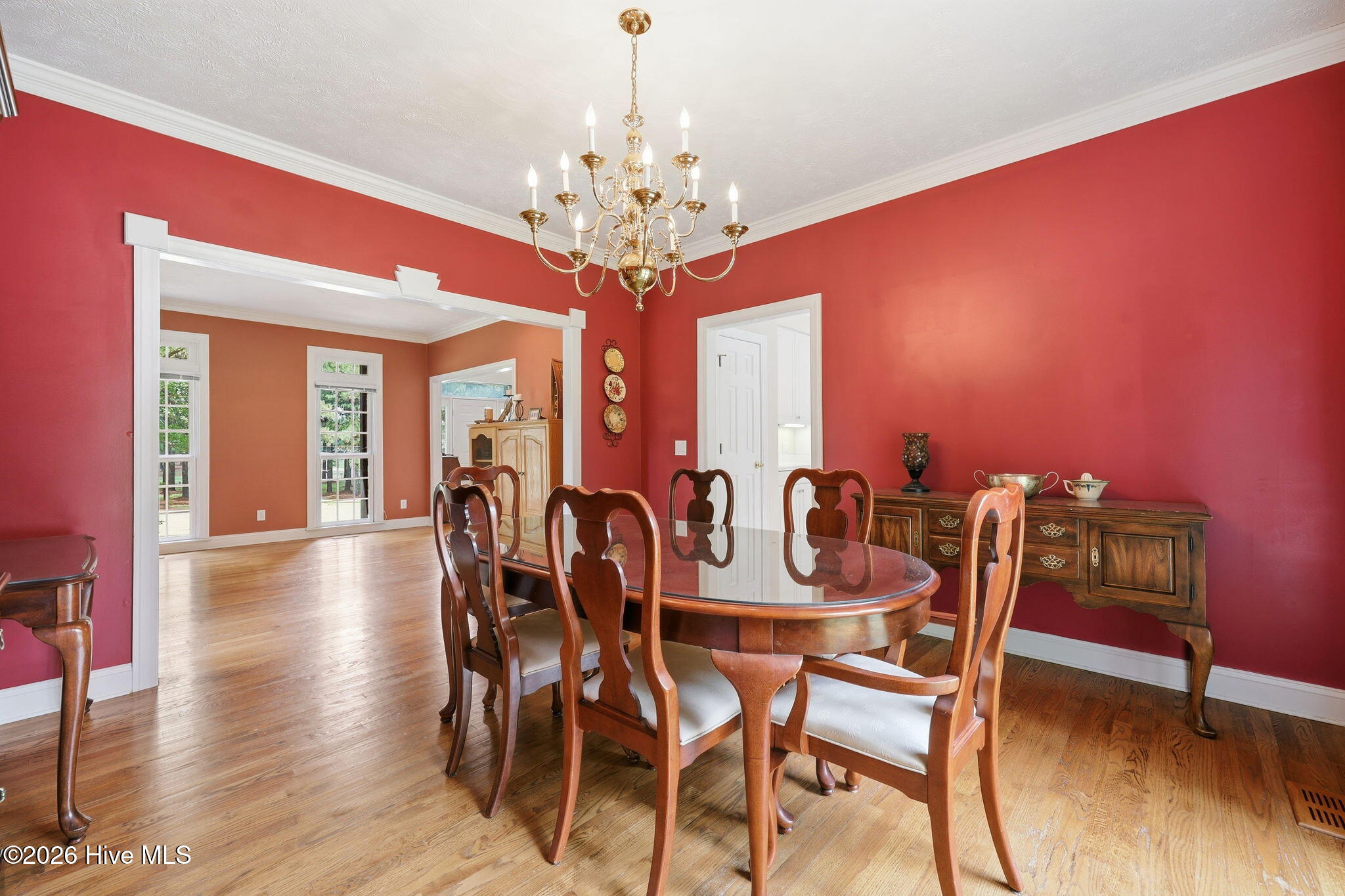 4076 Mobleys Bridge Road Grimesland, NC 27837 - Photo 13 of 66 transition to the formal dining with detailed trim work and all wood floors throughout for flow