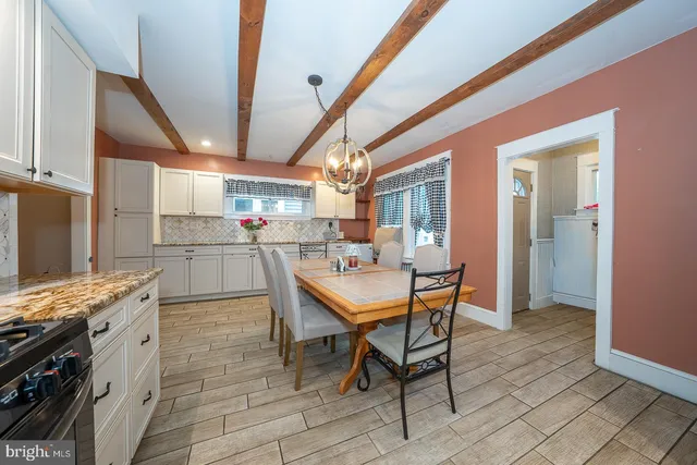a view of a dining room with furniture and a wooden floor
