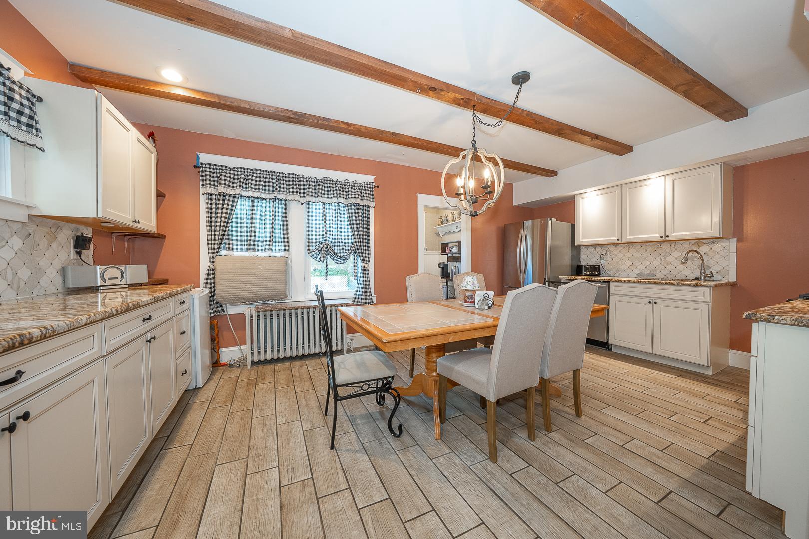 119 Wilson Avenue Havertown, PA 19083 - Photo 16 of 31 a dining room with stainless steel appliances kitchen island granite countertop furniture and wooden floor