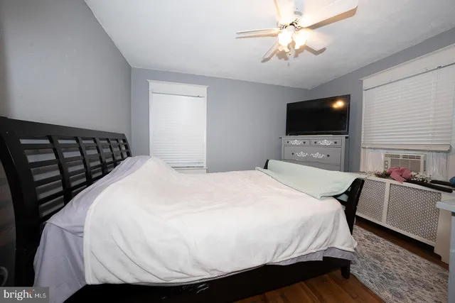 a bedroom with a bed and a painting on the wall