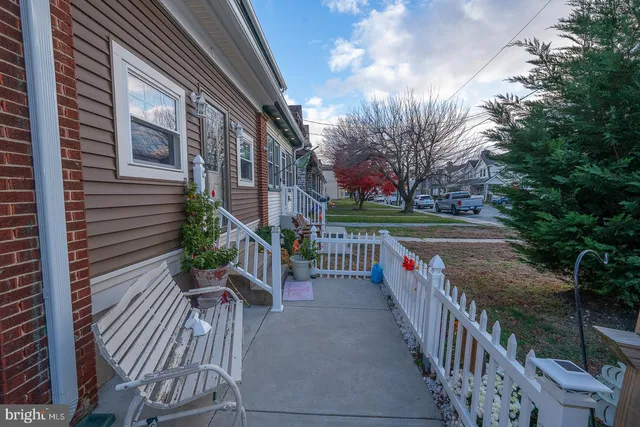 a view of a porch with furniture and wooden fence