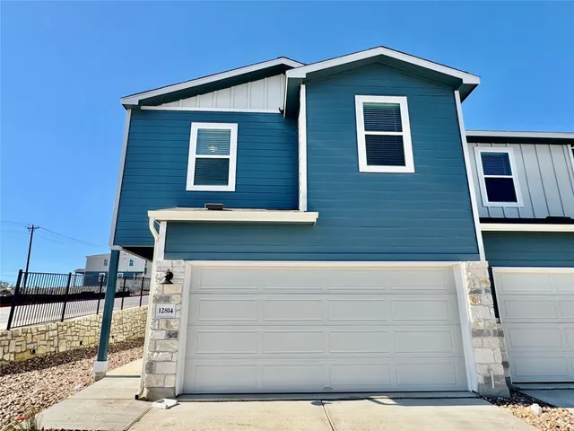 a front view of a house with garage