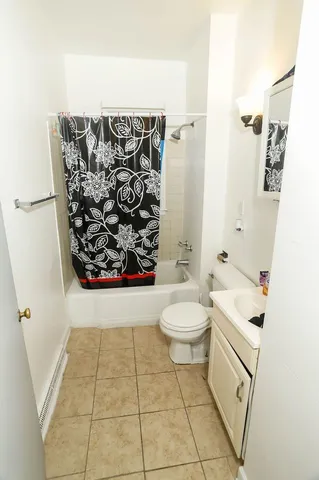 a bathroom with a toilet sink and shower