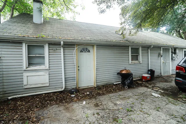 a view of a house with a backyard and a table