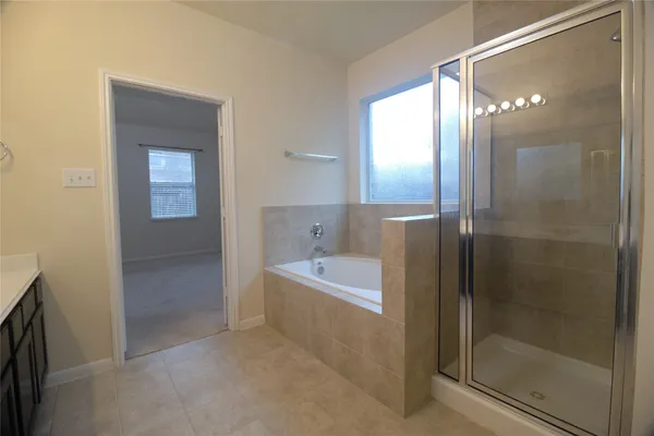 a bathroom with a bathtub and a shower