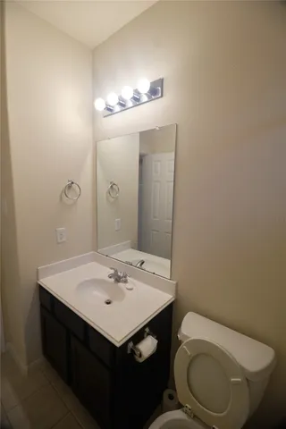 a bathroom with a sink a toilet and mirror