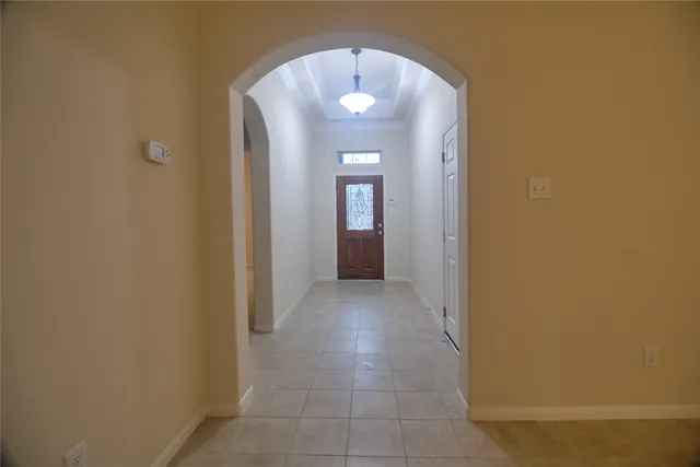 a view of a hallway with wooden shelves