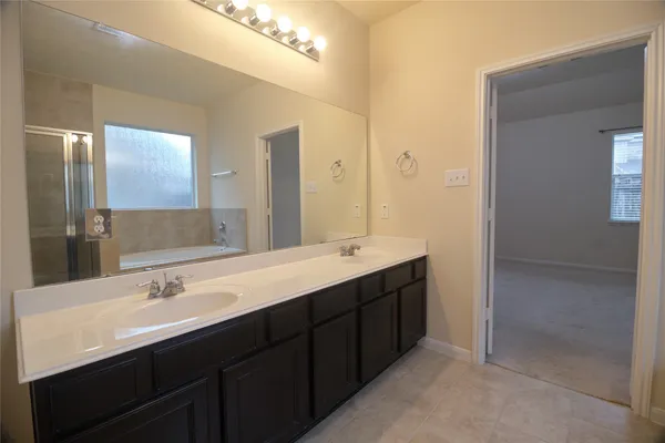 a bathroom with a double vanity sink and a mirror