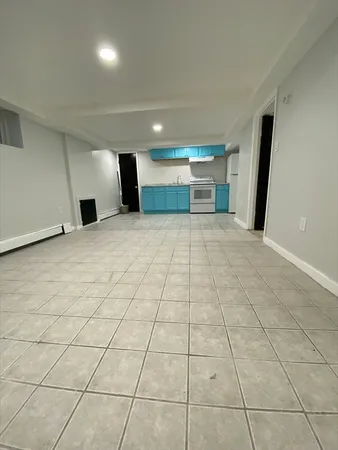 a view of a livingroom with an empty space and a window