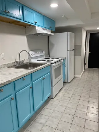 a view of a kitchen with a sink and cabinets