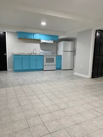 a kitchen with stainless steel appliances a stove a sink and a refrigerator
