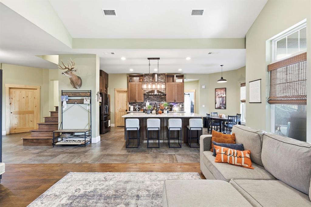 3300 Rigsby Lane Celina, TX 75009 - Photo 12 of 40 a living room with furniture and a dining table with kitchen view