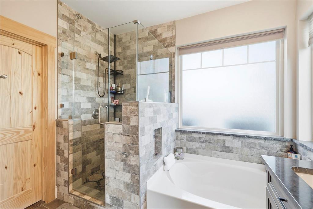 3300 Rigsby Lane Celina, TX 75009 - Photo 21 of 40 a bathroom with a bathtub and a shower