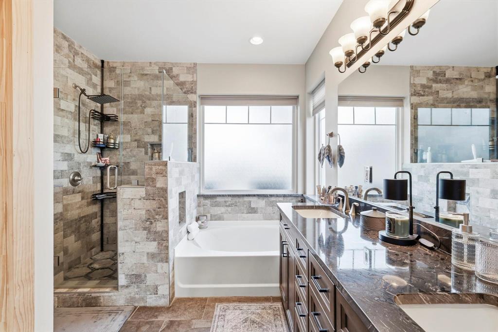 3300 Rigsby Lane Celina, TX 75009 - Photo 22 of 40 a bathroom with a granite countertop double vanity sink a mirror and a shower