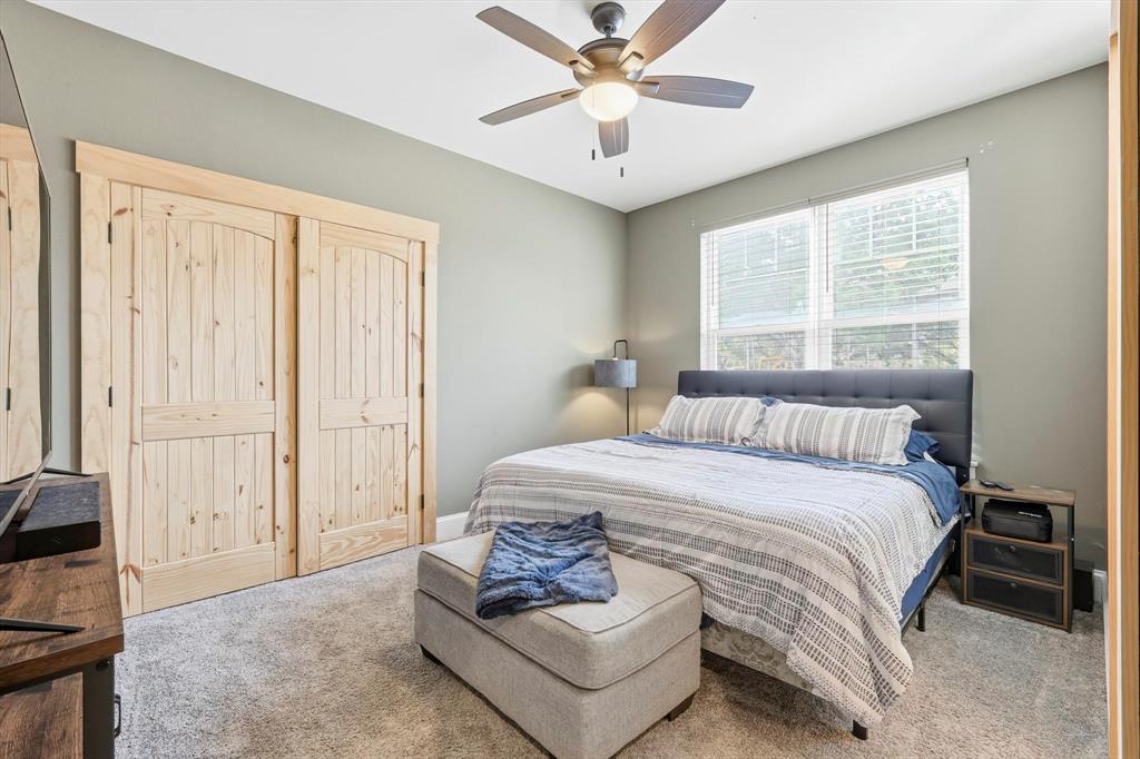 3300 Rigsby Lane Celina, TX 75009 - Photo 24 of 40 a bedroom with a bed and a chandelier