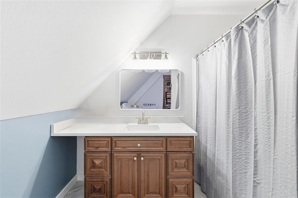 3300 Rigsby Lane Celina, TX 75009 - Photo 35 of 40 a bathroom with a sink and a mirror