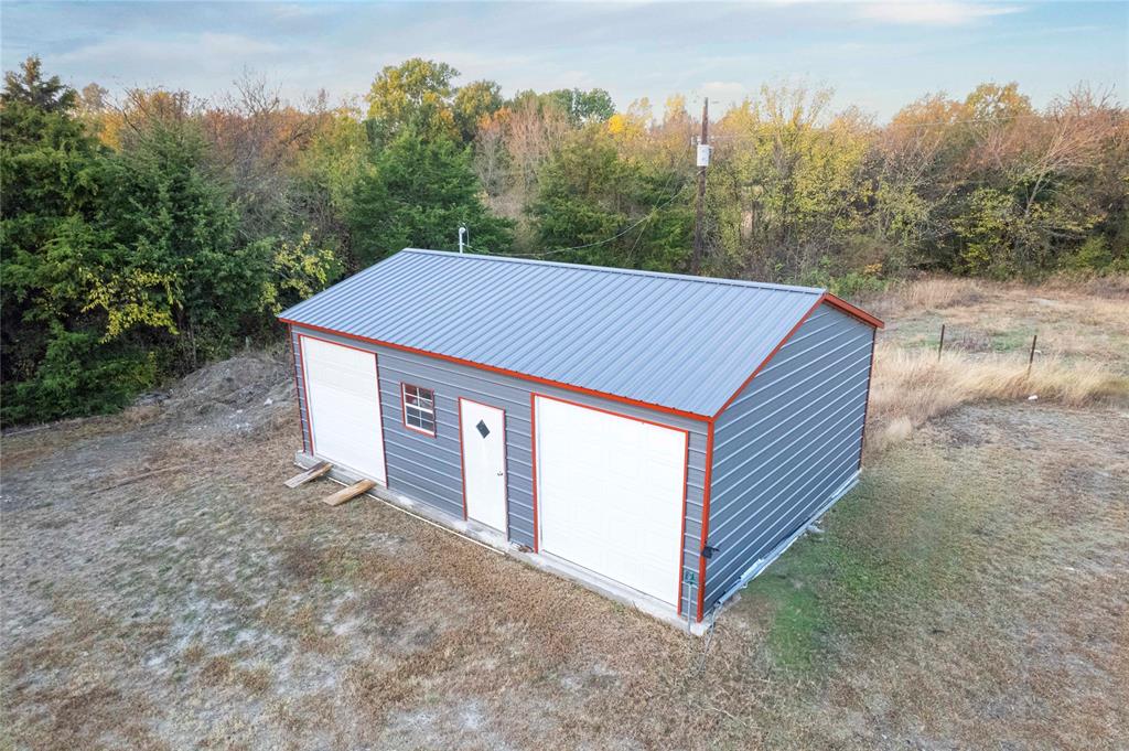 3300 Rigsby Lane Celina, TX 75009 - Photo 39 of 40 a backyard of a house with large trees and a barn