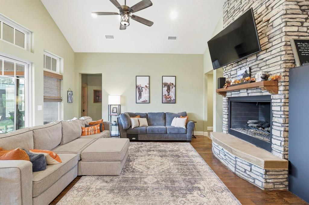 3300 Rigsby Lane Celina, TX 75009 - Photo 9 of 40 a living room with furniture a flat screen tv and a fireplace