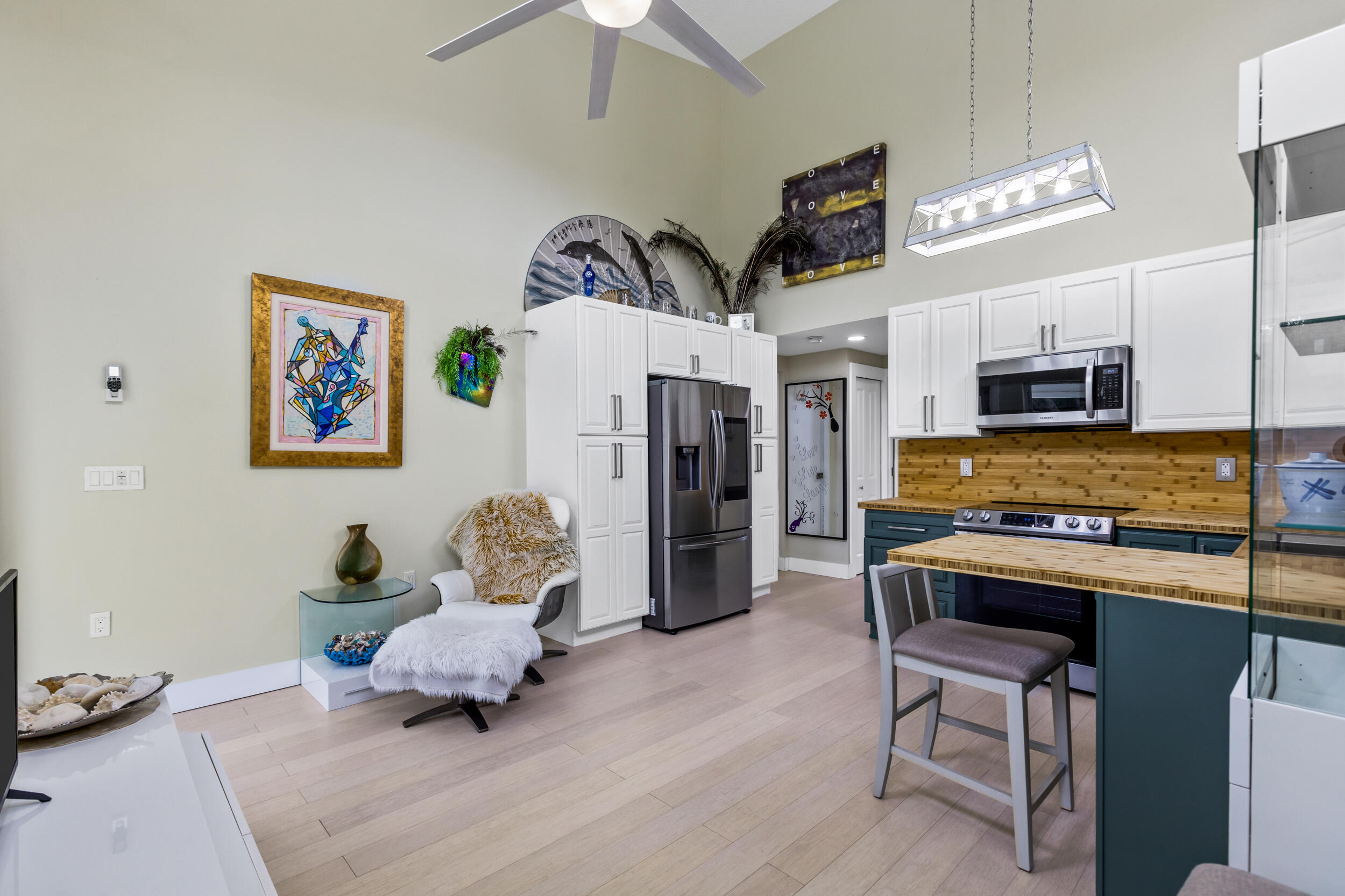 204 Flamingo Road Cocoa, FL 32926 - Photo 3 of 18 a living room with stainless steel appliances furniture and a flat screen tv