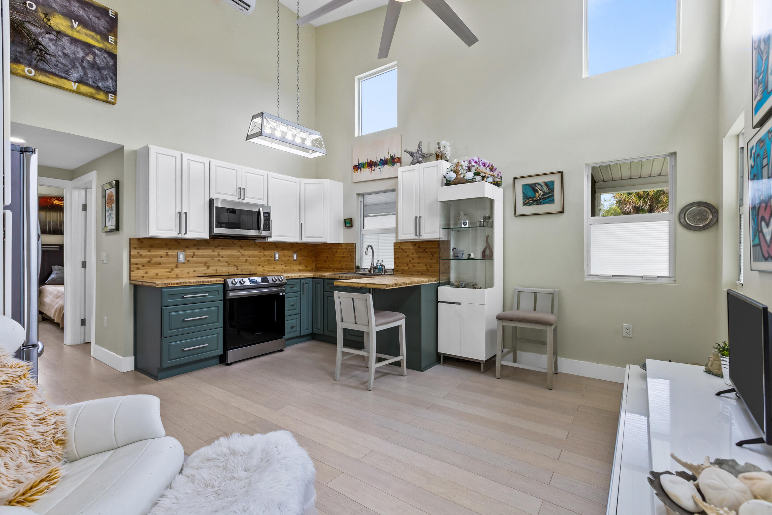 204 Flamingo Road Cocoa, FL 32926 - Photo 4 of 18 a large kitchen with cabinets wooden floor and stainless steel appliances