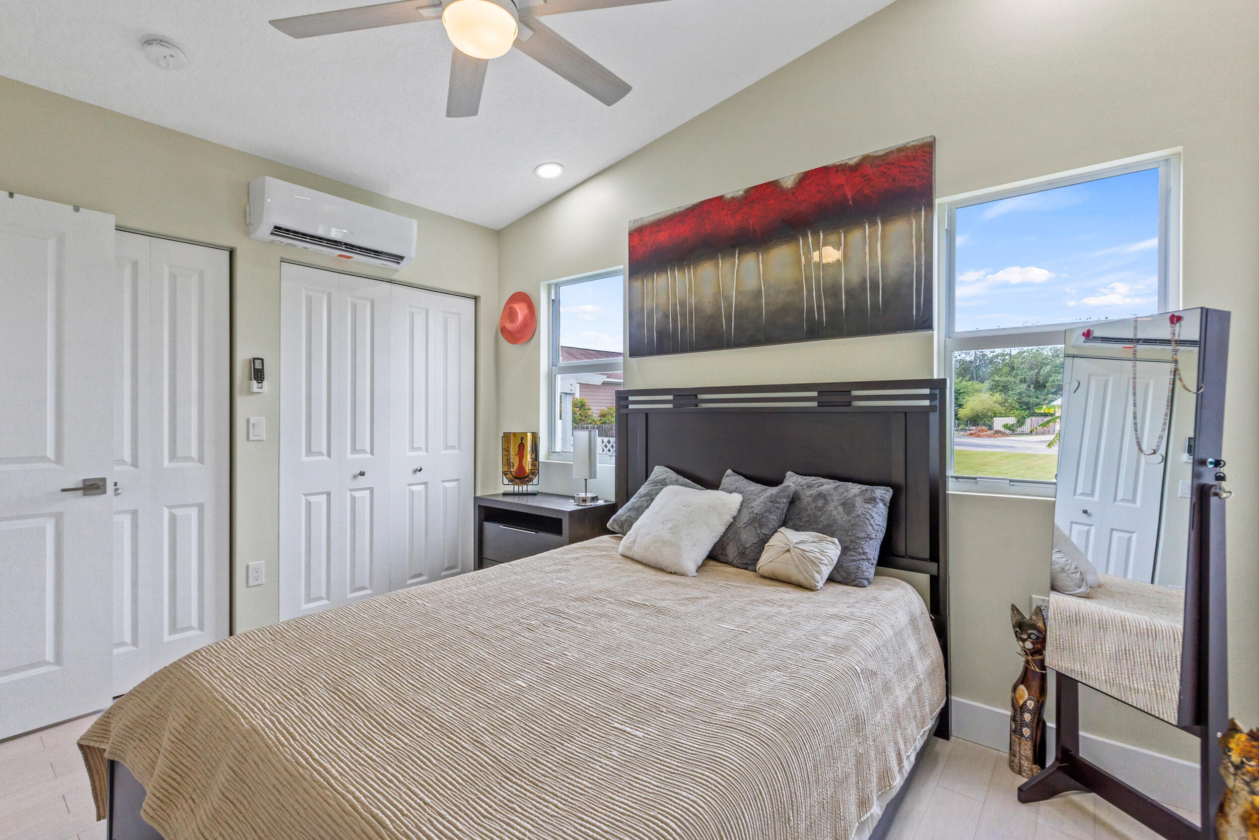 204 Flamingo Road Cocoa, FL 32926 - Photo 9 of 18 a bedroom with a large bed and a chandelier