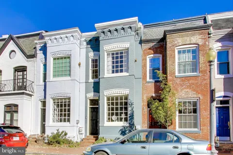 a front view of a residential apartment building with a yard