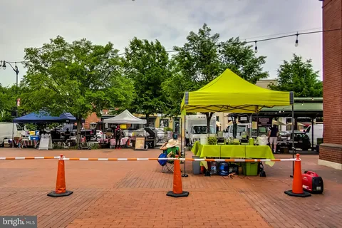 a building outdoor space with lots of cars and trees