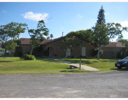 a house that has a tree in front of it