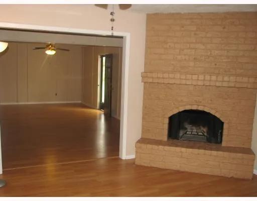 a view of a livingroom with a fireplace and window