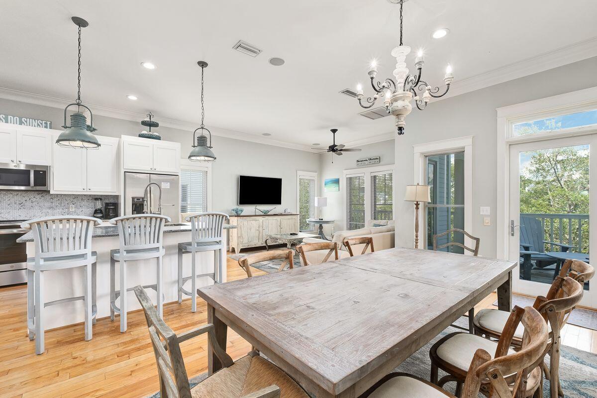 40 Chelsea Loop Road Santa Rosa Beach, FL 32459 - Photo 11 of 46 a view of a dining room with furniture wooden floor and chandelier