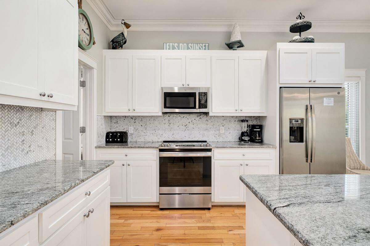 40 Chelsea Loop Road Santa Rosa Beach, FL 32459 - Photo 21 of 46 a kitchen with stainless steel appliances granite countertop a stove a sink and a microwave