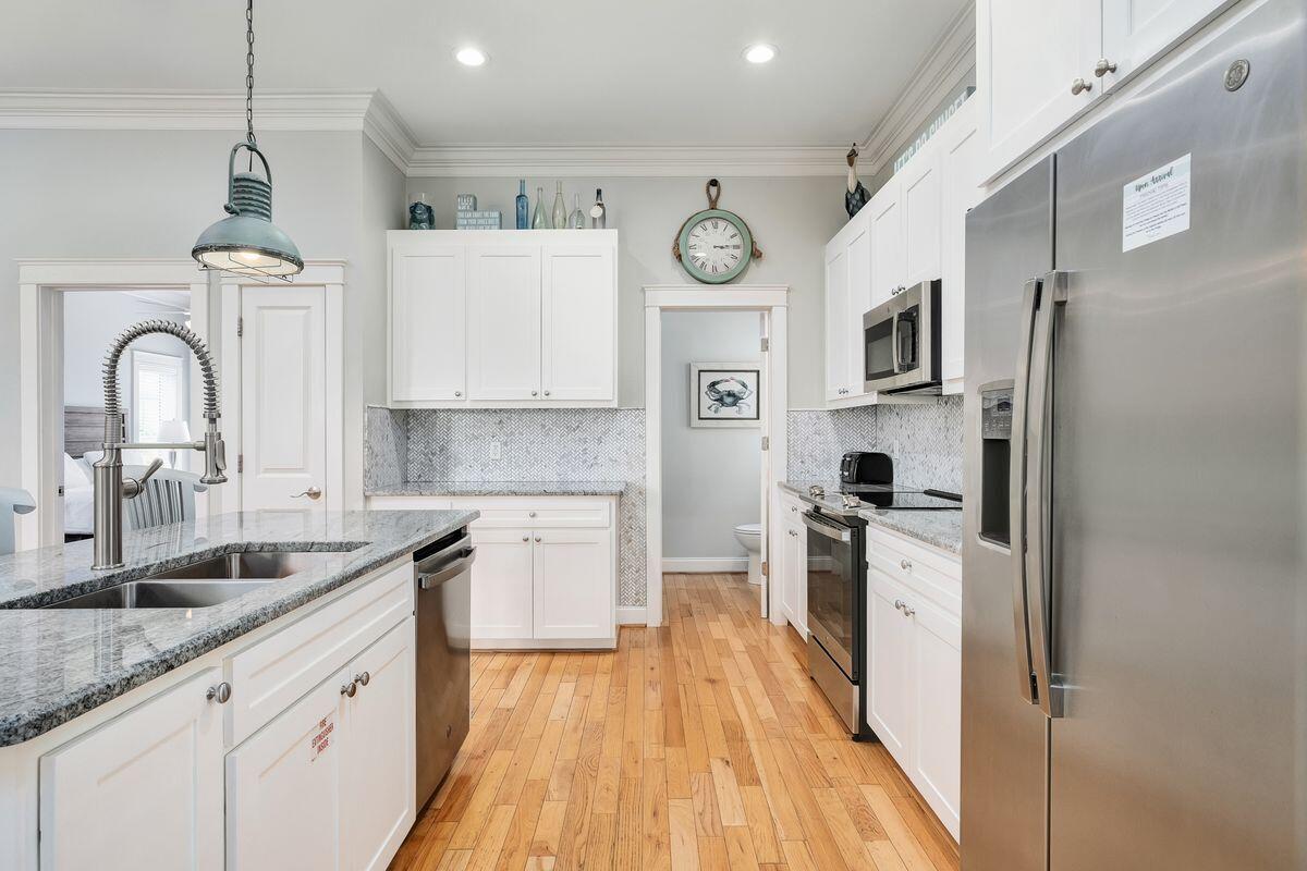 40 Chelsea Loop Road Santa Rosa Beach, FL 32459 - Photo 22 of 46 a kitchen with stainless steel appliances granite countertop a stove a sink and a refrigerator